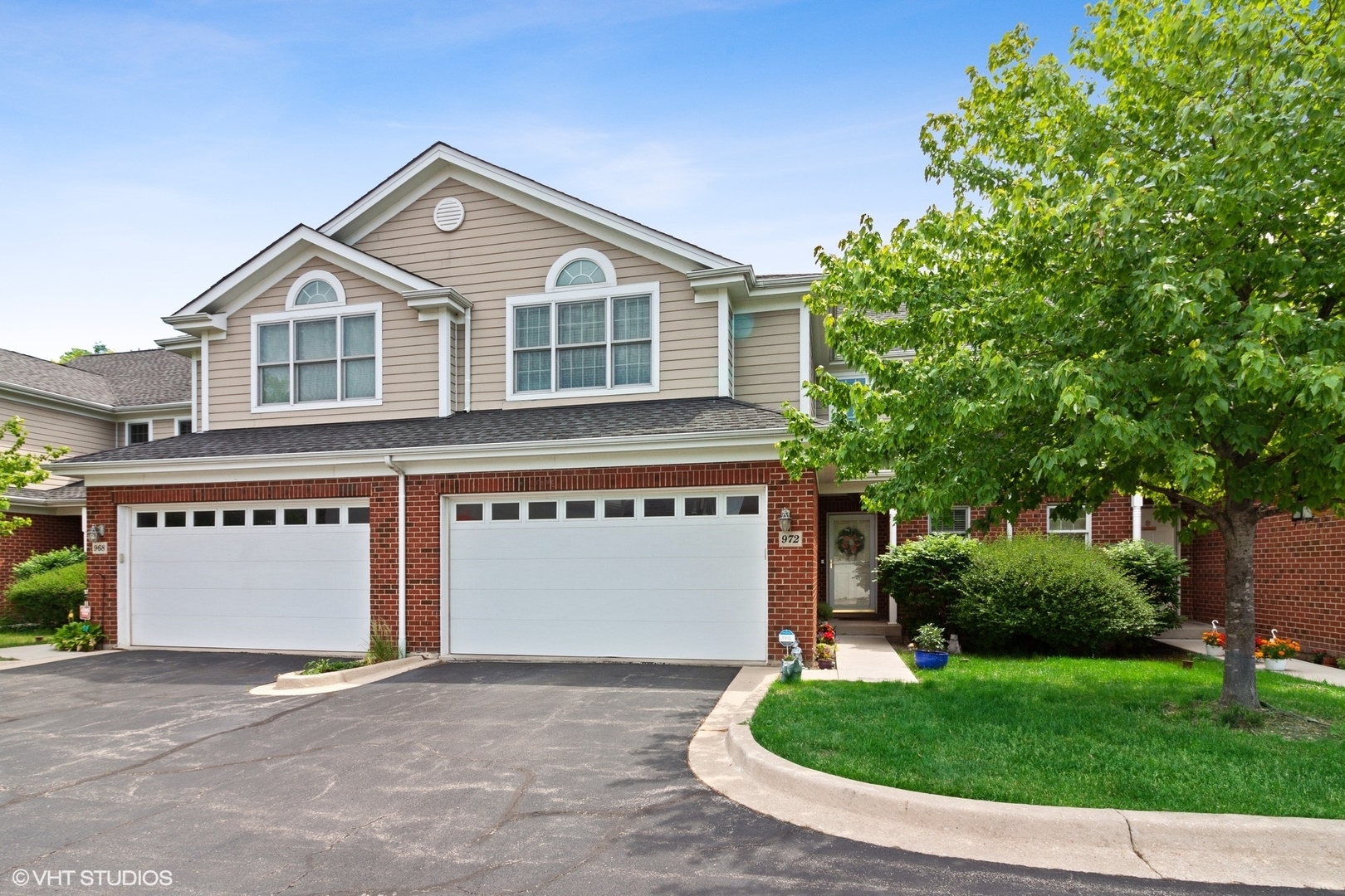 a view of a house with a yard and garage