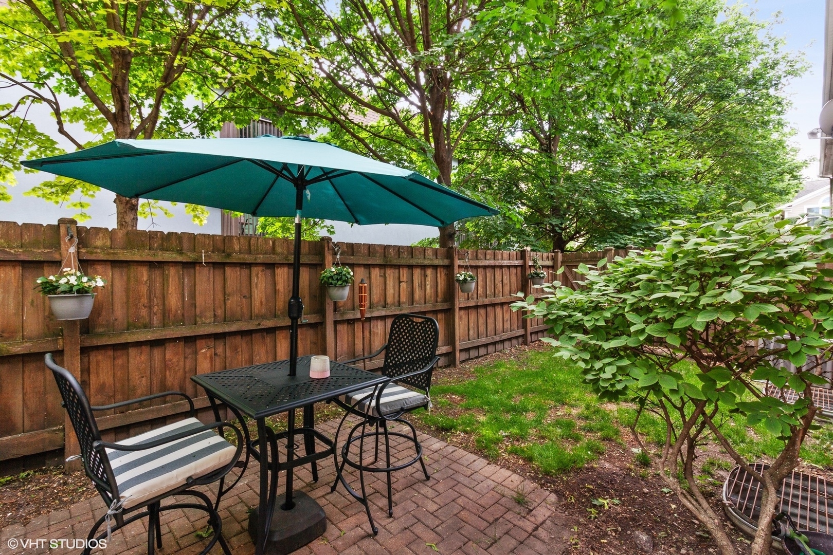 972 West Irving Park Road, Unit 3 Bensenville, IL 60106 - Photo 19 of 19 a backyard of a house with table and chairs under an umbrella