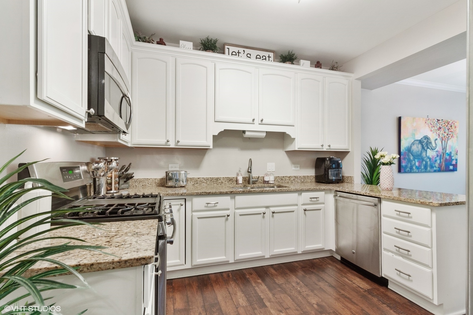 972 West Irving Park Road, Unit 3 Bensenville, IL 60106 - Photo 5 of 19 a kitchen with stainless steel appliances granite countertop a sink and cabinets with wooden floor