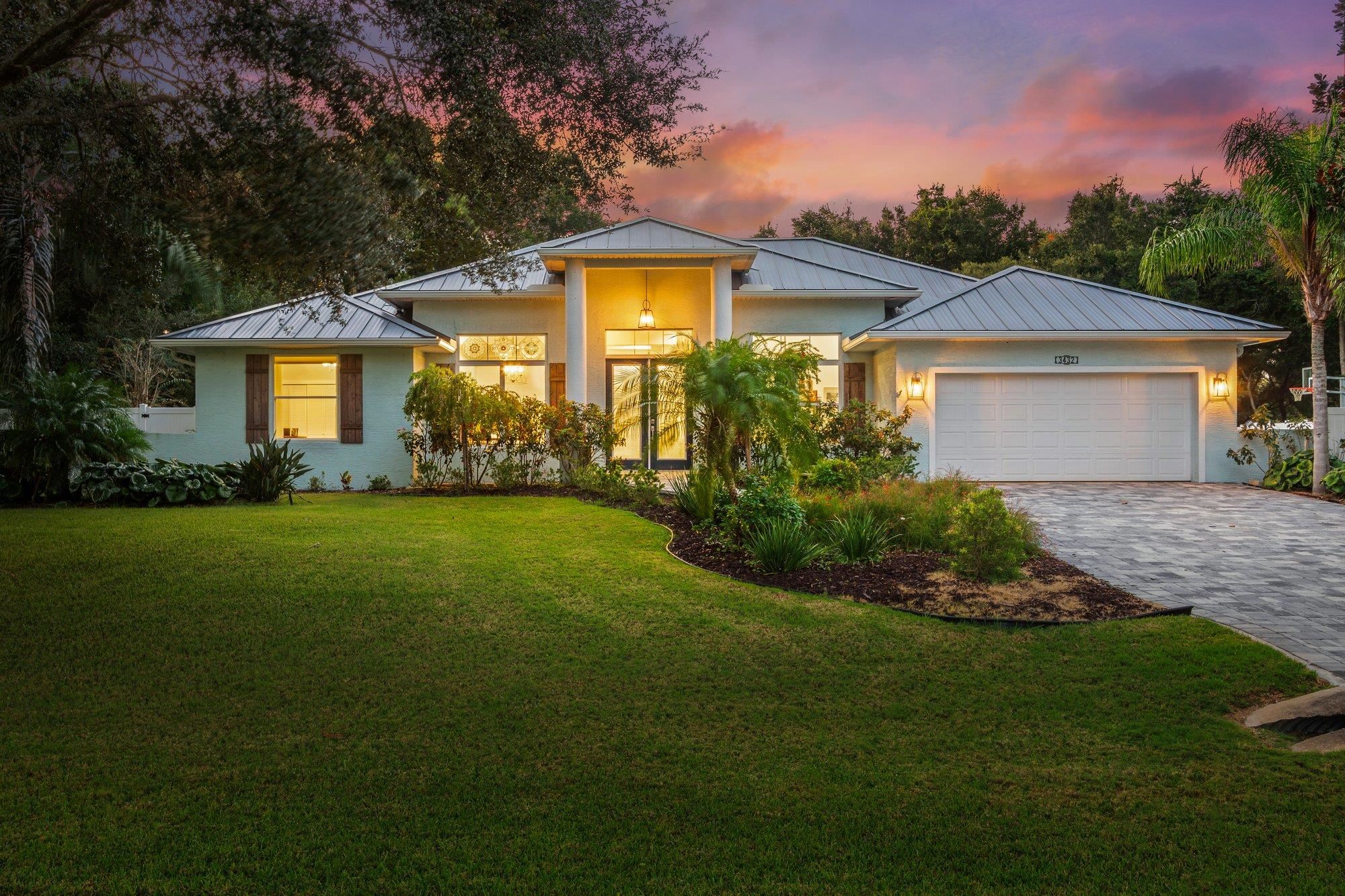 a front view of house with yard and green space