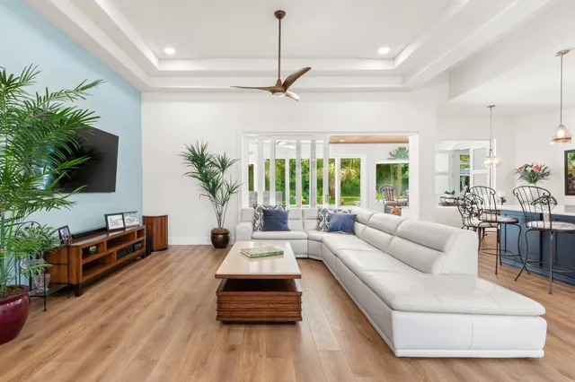 a living room with furniture windows and wooden floor