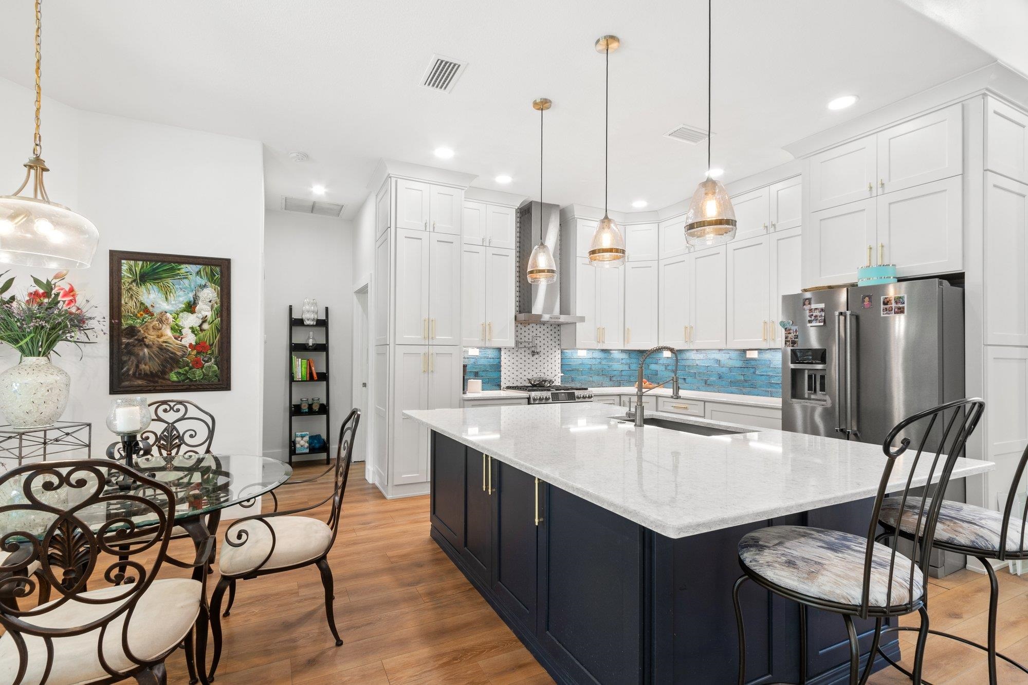 3432 Kings Road South St. Augustine, FL 32086 - Photo 15 of 47 a kitchen with stainless steel appliances a dining table chairs and couches