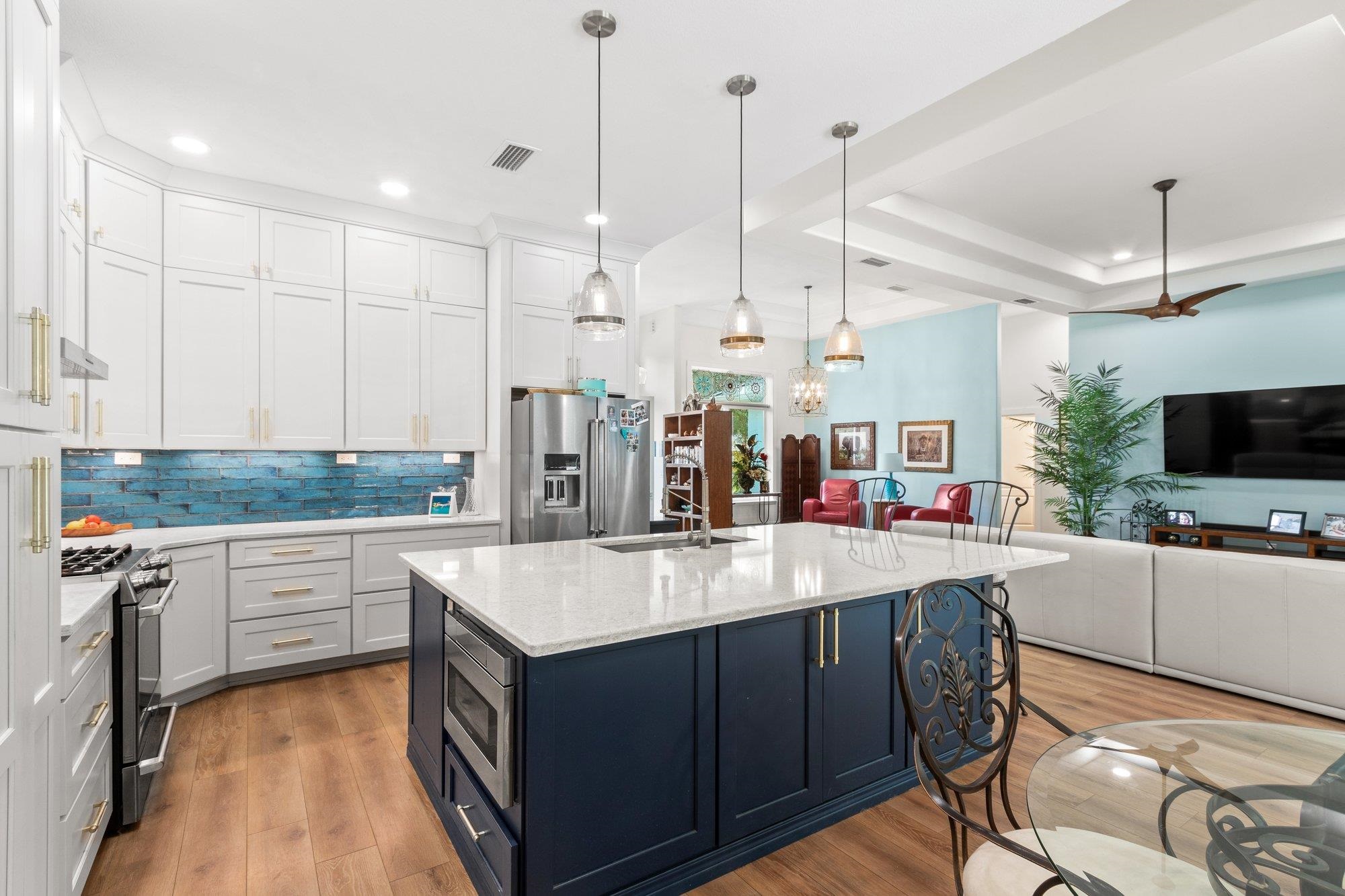 3432 Kings Road South St. Augustine, FL 32086 - Photo 18 of 47 a large kitchen with kitchen island a large island in it