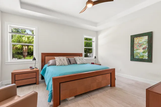 a bedroom with a bed and a couch next to a window