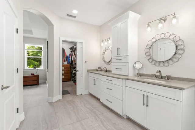 a spacious bathroom with a granite countertop sink and a mirror