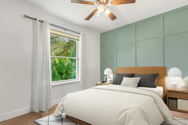 a bedroom with a large bed and a chandelier
