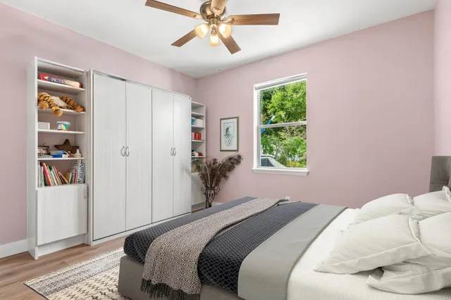 a bedroom with a bed and a window