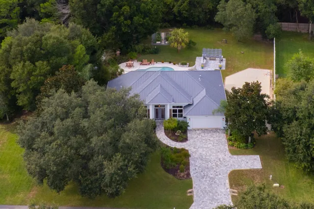 an aerial view of a house with swimming pool and outdoor space