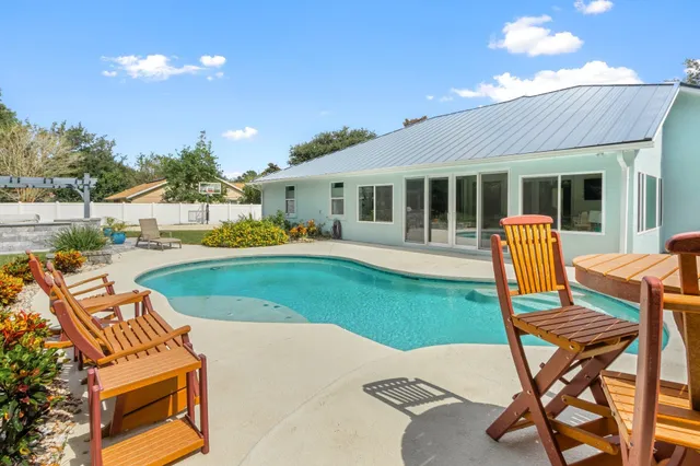 a patio with a table and chairs