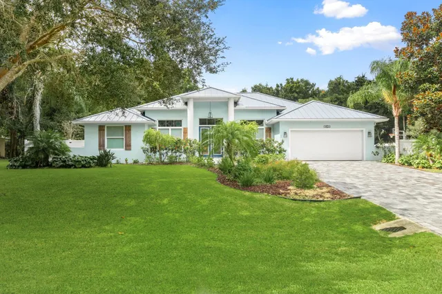 a front view of a house with a garden