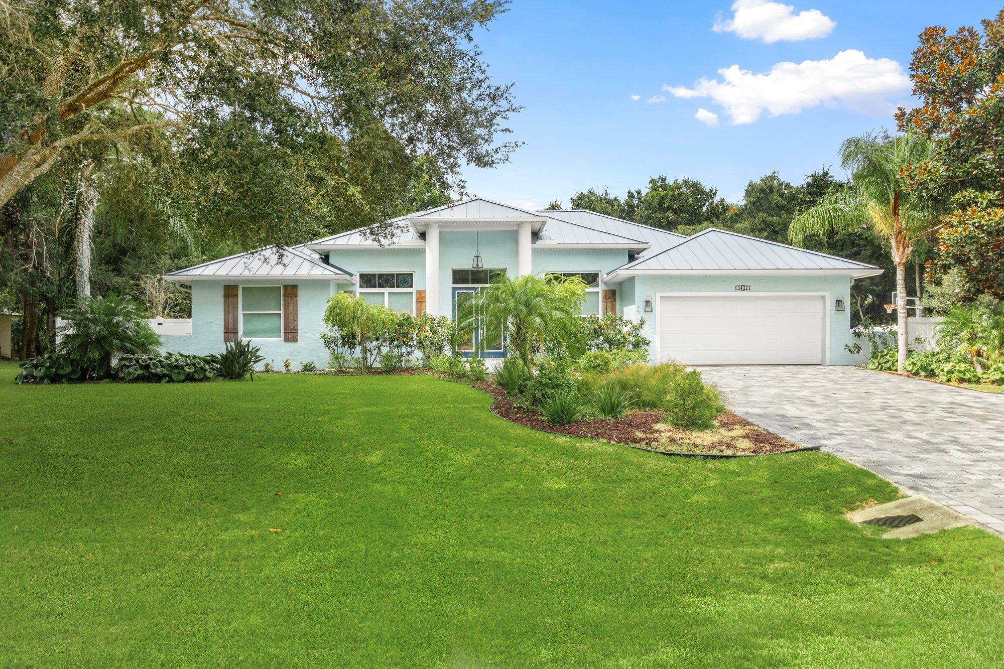 3432 Kings Road South St. Augustine, FL 32086 - Photo 4 of 47 a front view of a house with a garden