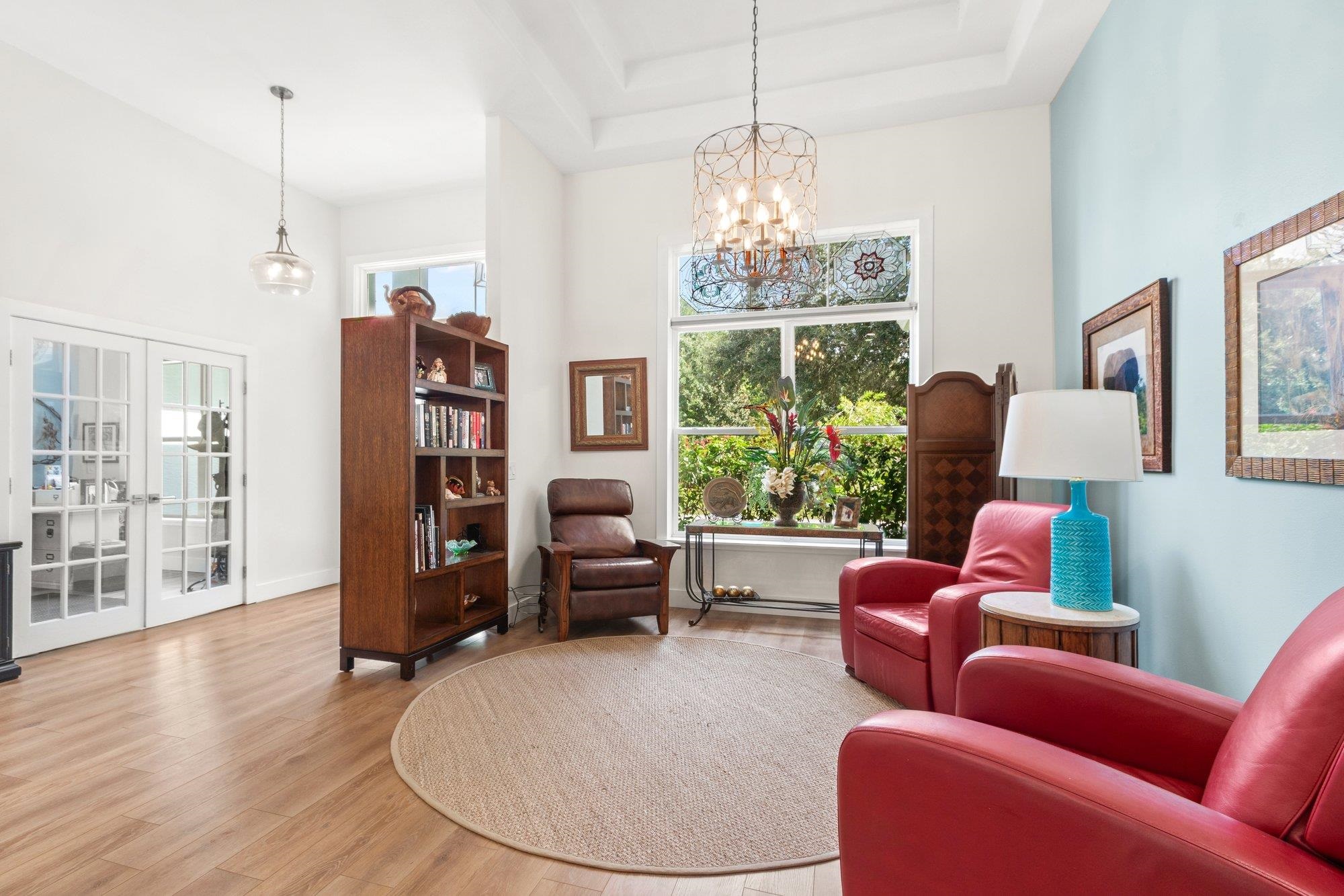 3432 Kings Road South St. Augustine, FL 32086 - Photo 8 of 47 a living room with furniture a chandelier and wooden floor