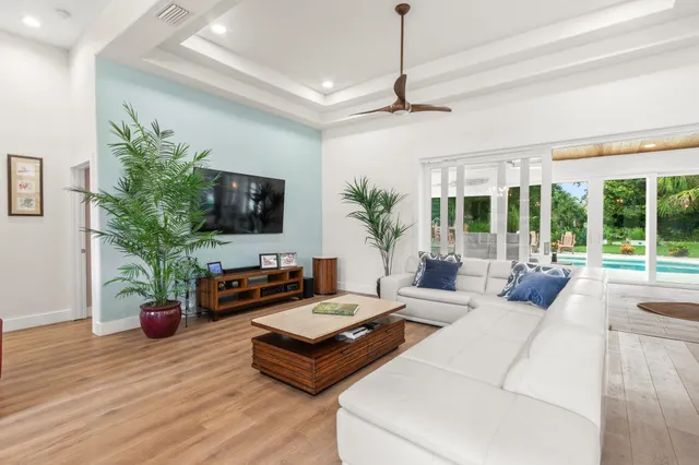 a living room with furniture a large window and a flat screen tv