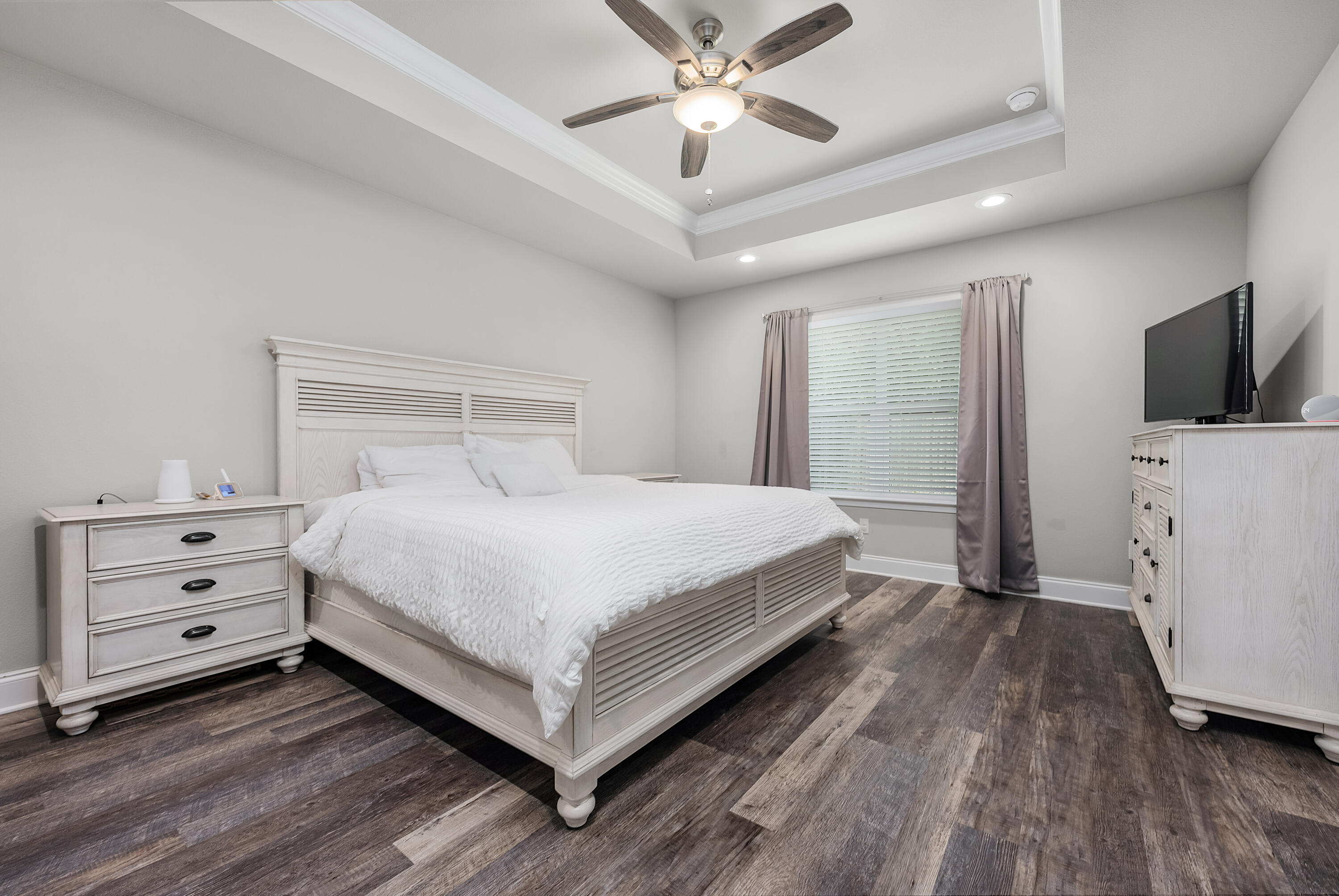 820 Hilltop Road Mary Esther, FL 32569 - Photo 31 of 47 a bedroom with a bed and a flat tv screen on dresser