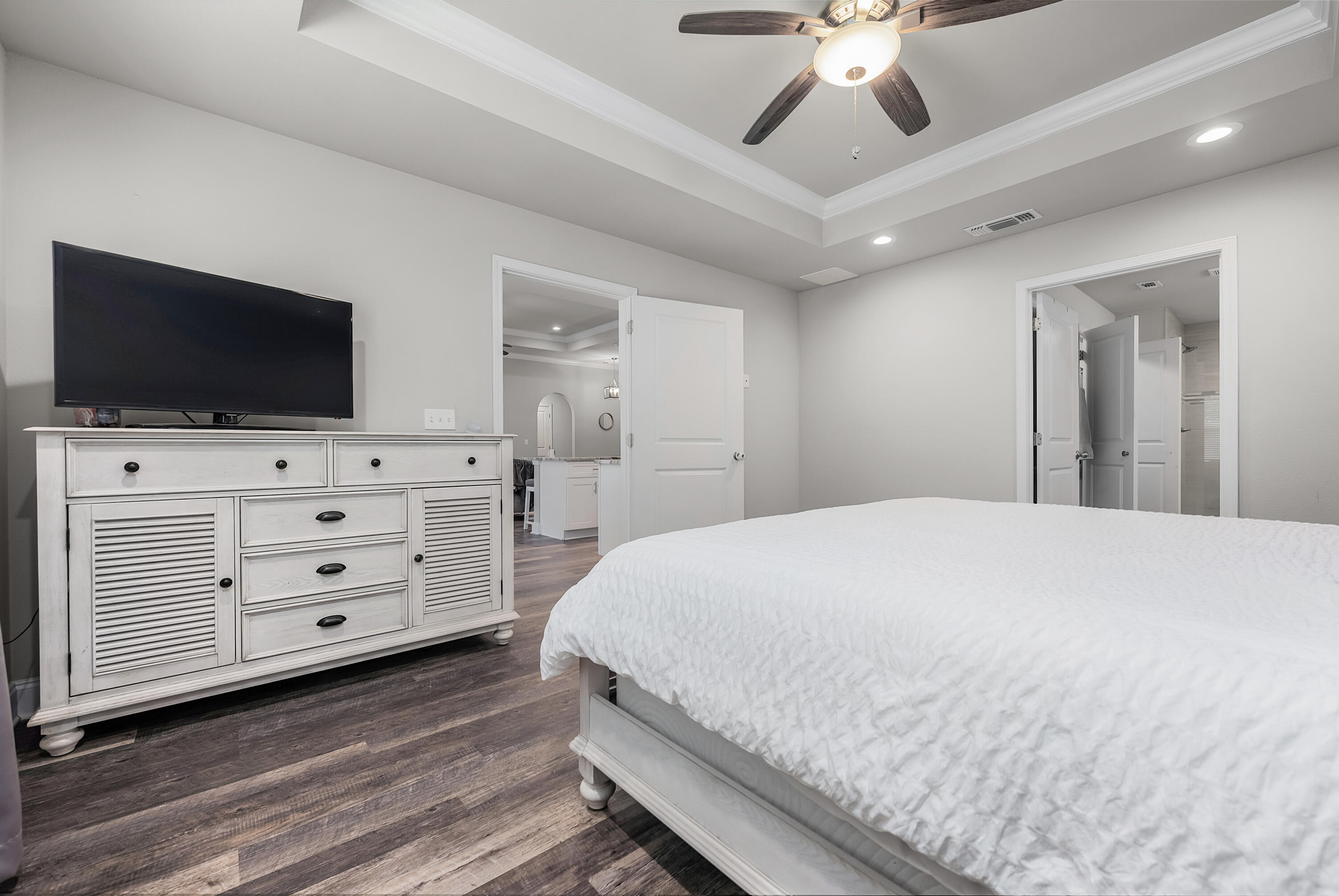 820 Hilltop Road Mary Esther, FL 32569 - Photo 34 of 47 a bedroom with a bed a flat screen tv and a chandelier