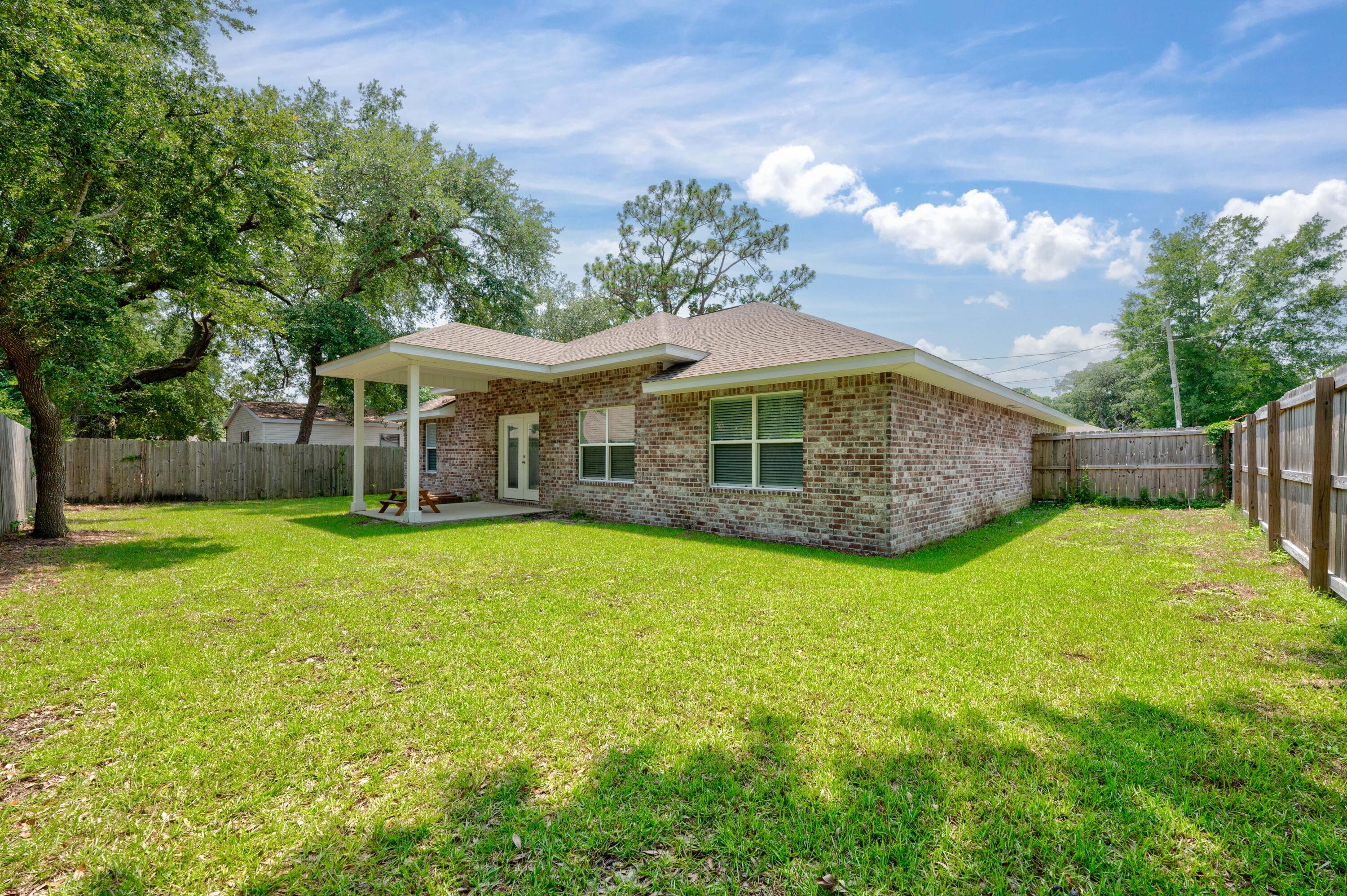 820 Hilltop Road Mary Esther, FL 32569 - Photo 46 of 47 a view of a house with a backyard