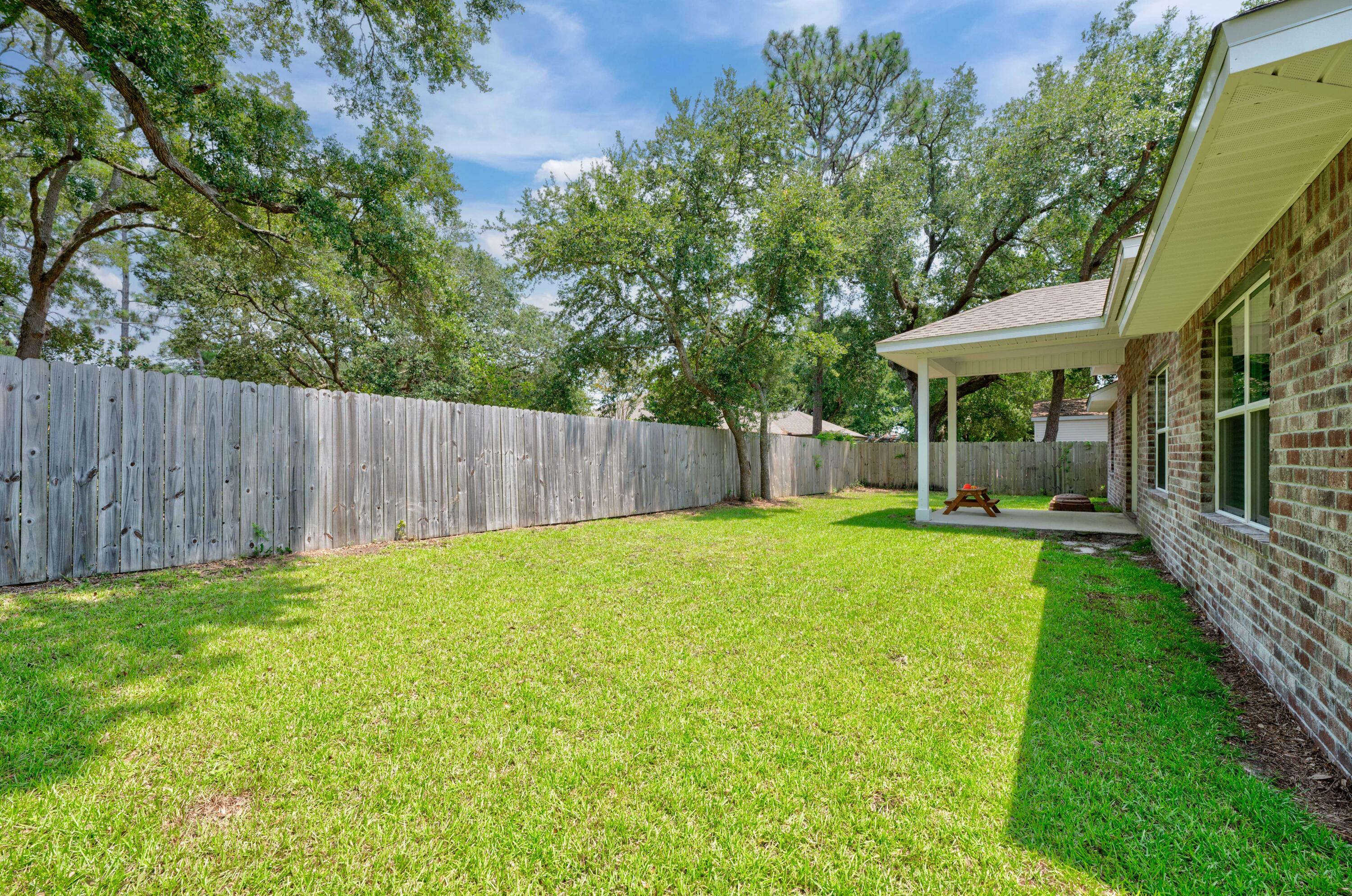 820 Hilltop Road Mary Esther, FL 32569 - Photo 47 of 47 a view of a backyard with a garden and entertaining space