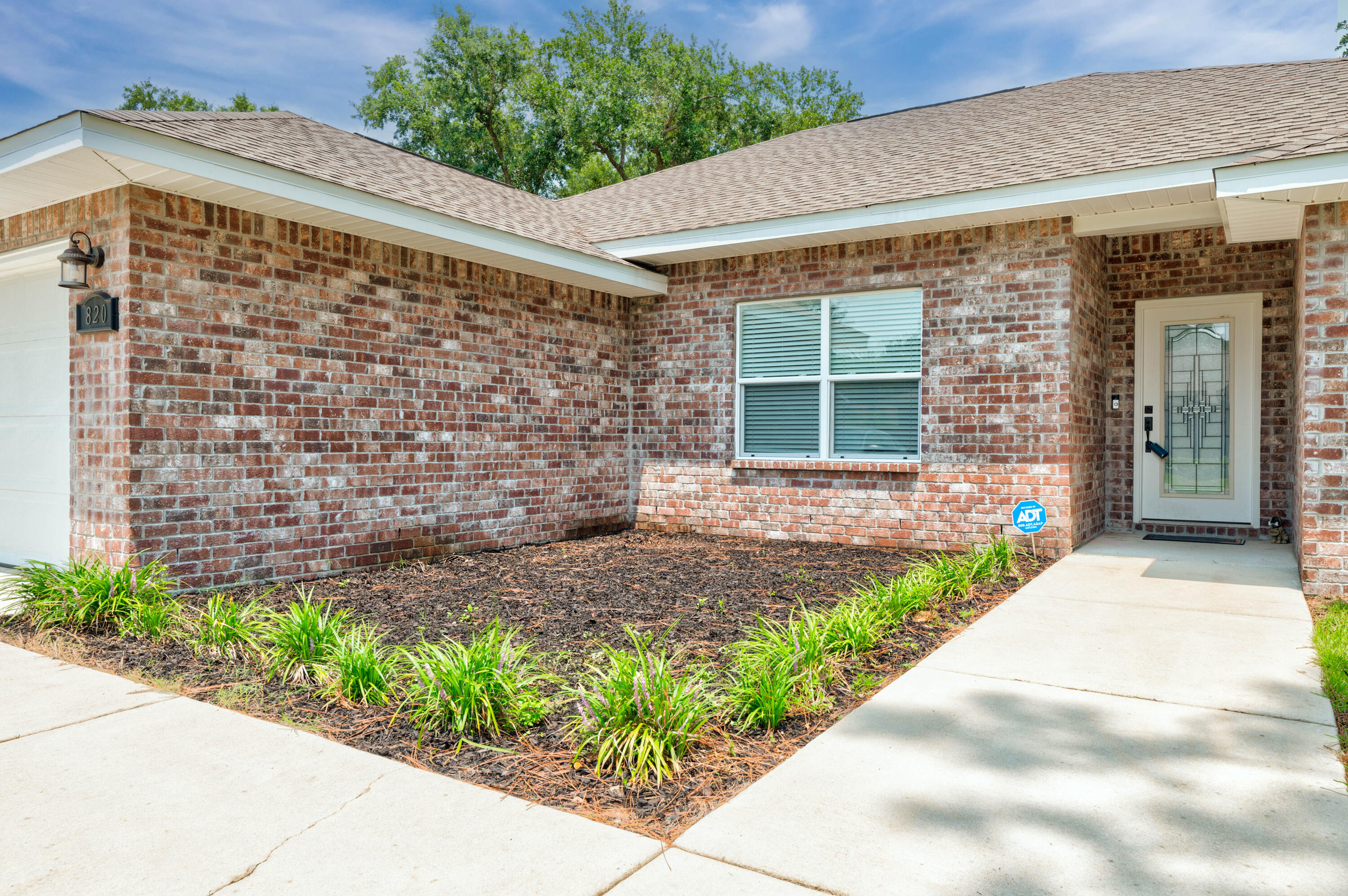 820 Hilltop Road Mary Esther, FL 32569 - Photo 5 of 47 a front view of a house with a garden