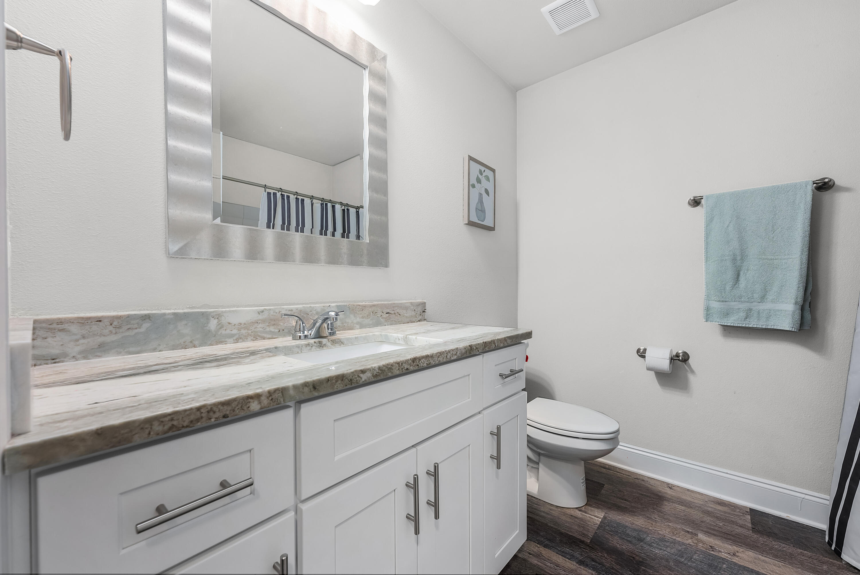 820 Hilltop Road Mary Esther, FL 32569 - Photo 9 of 47 a bathroom with a granite countertop toilet sink and mirror