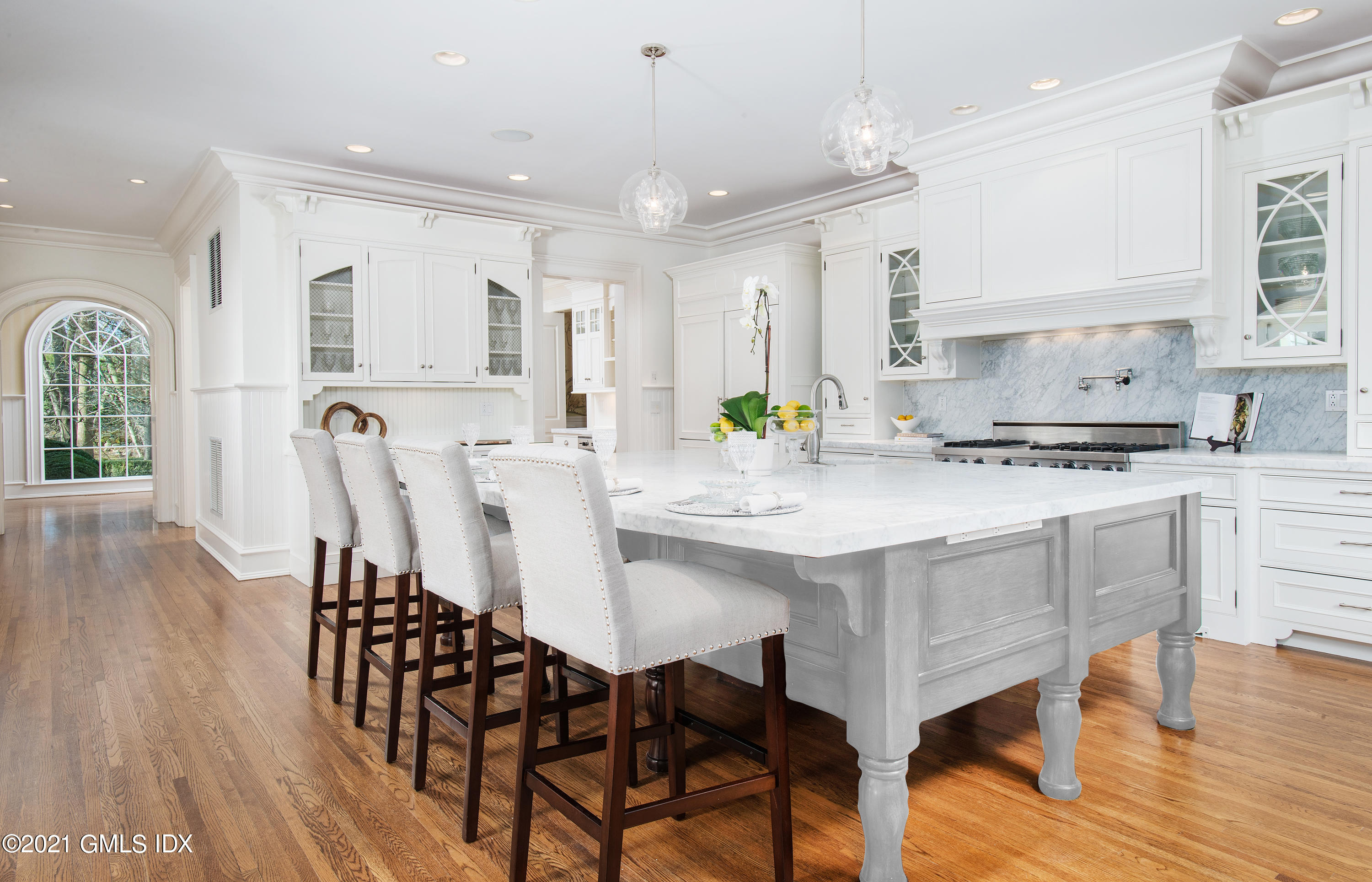 65 Clapboard Ridge Road Greenwich, CT 06830 - Photo 13 of 36 a kitchen with stainless steel appliances granite countertop a stove a table and chairs in it