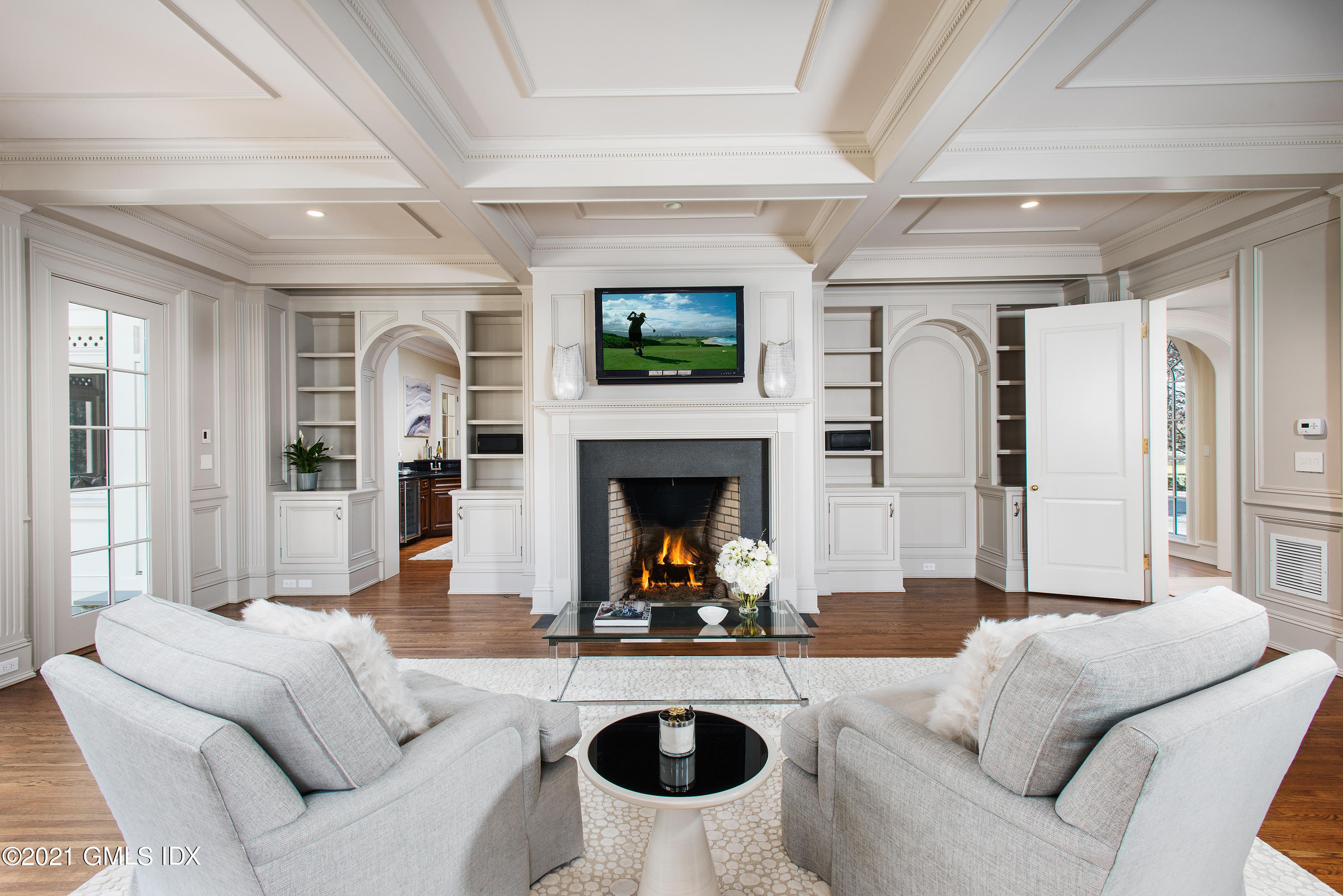 65 Clapboard Ridge Road Greenwich, CT 06830 - Photo 19 of 36 a living room with furniture a flat screen tv and a fireplace