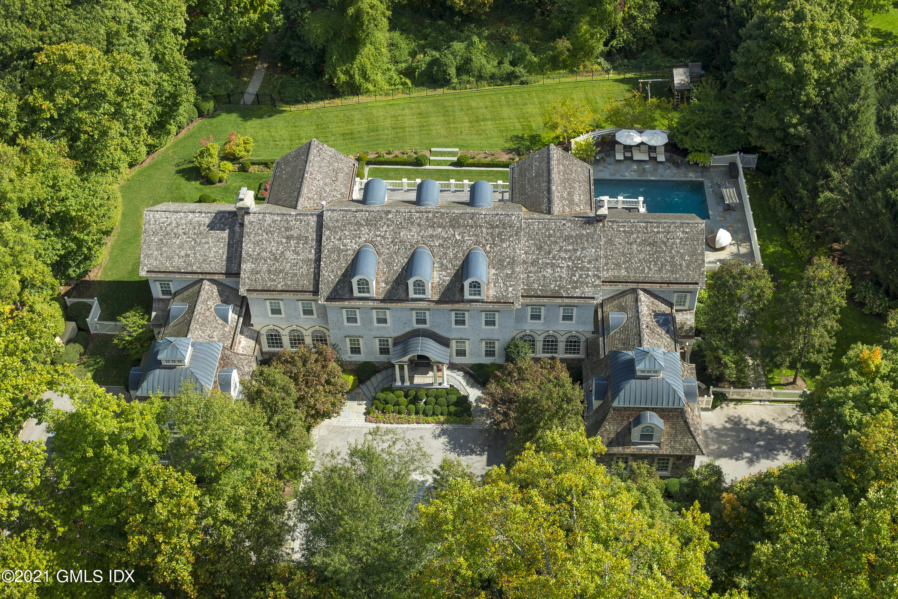 65 Clapboard Ridge Road Greenwich, CT 06830 - Photo 2 of 36 an aerial view of a house with a garden and lake view