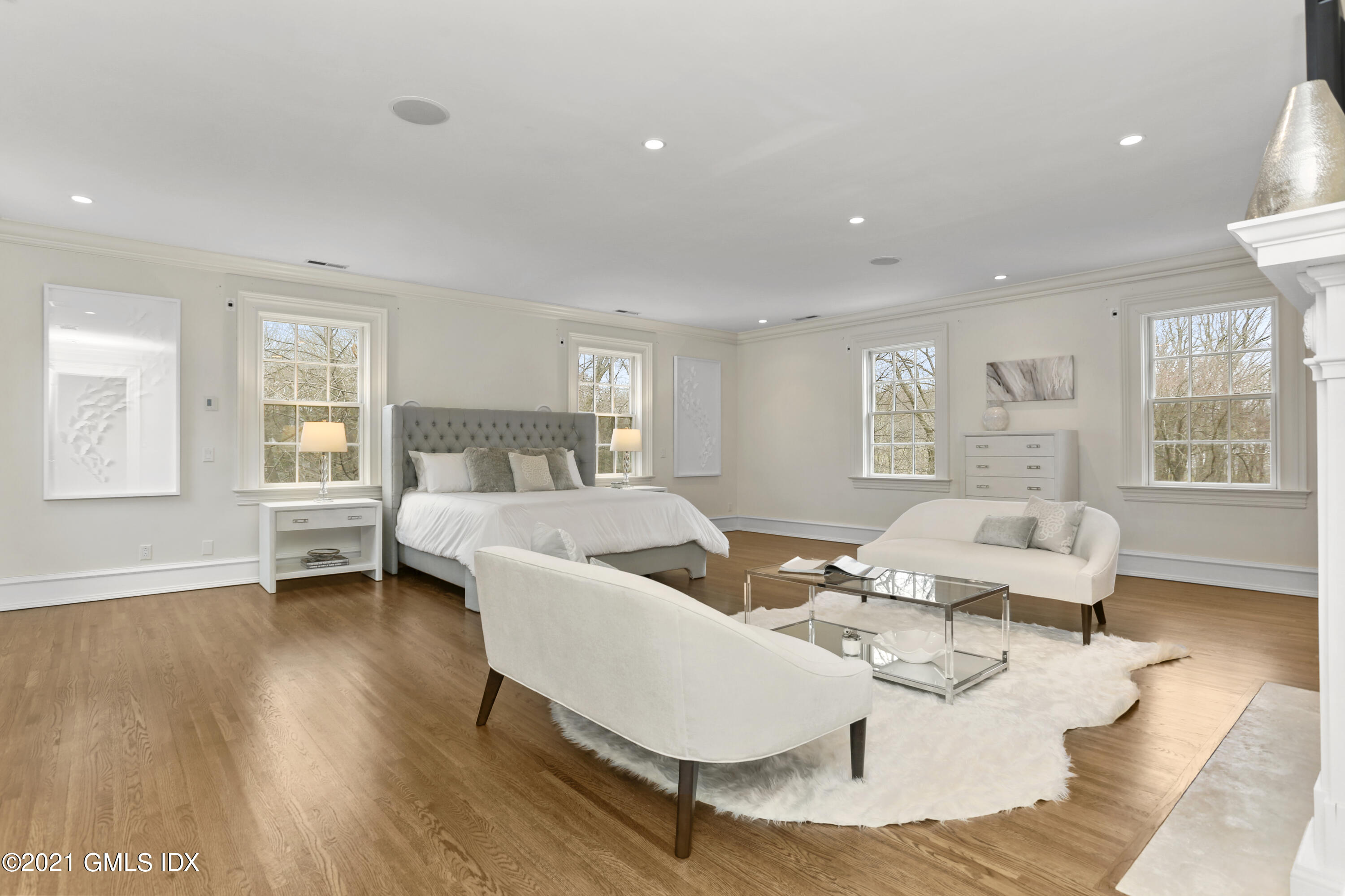 65 Clapboard Ridge Road Greenwich, CT 06830 - Photo 23 of 36 a living room with couches and a dining table with wooden floor