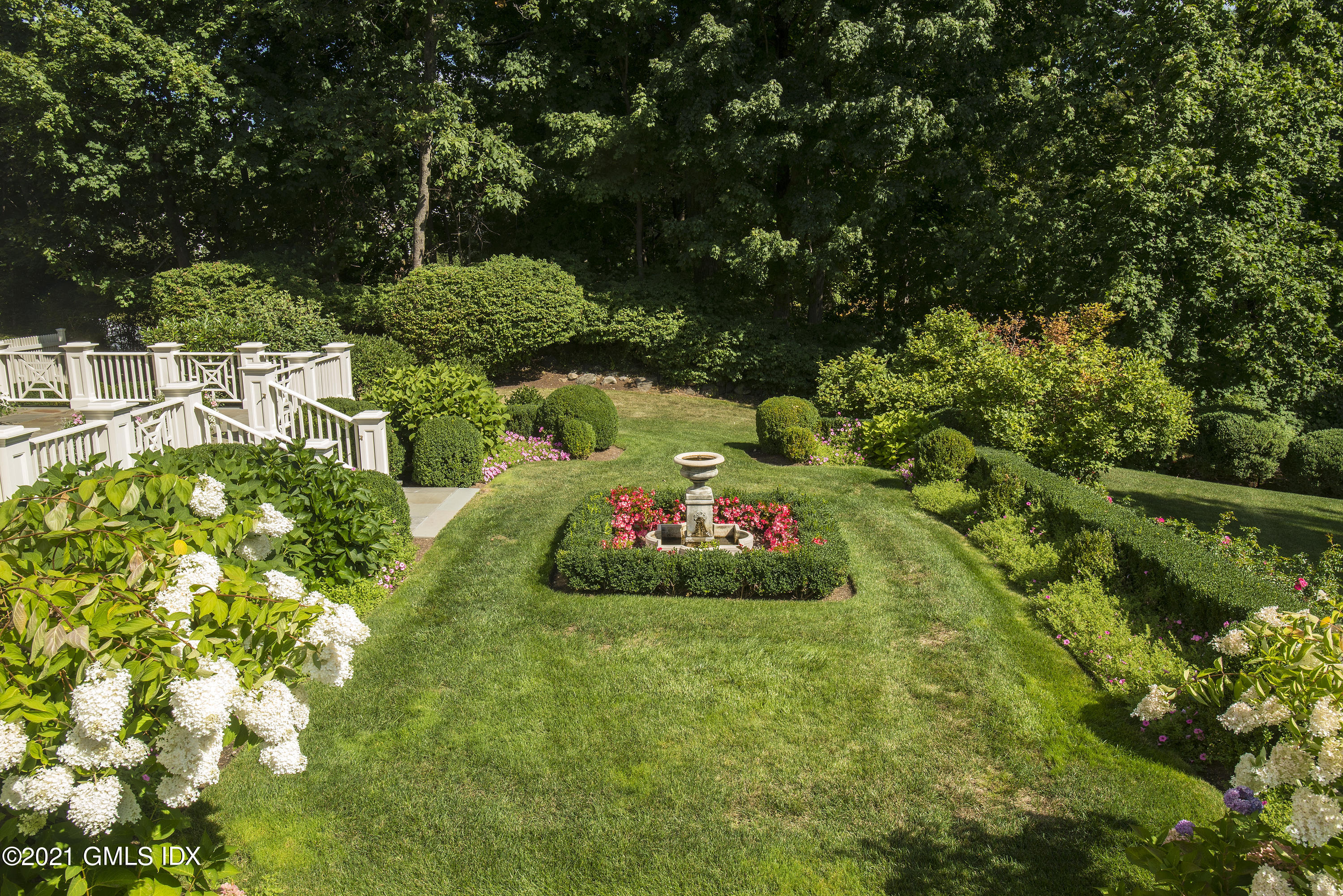 65 Clapboard Ridge Road Greenwich, CT 06830 - Photo 6 of 36 a view of a garden with plants and large trees