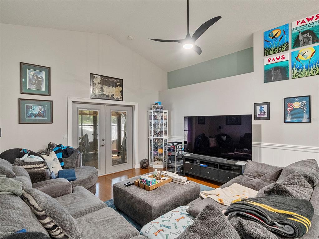 549 Placid Run Road Orange City, FL 32763 - Photo 12 of 20 a living room with furniture and a flat screen tv
