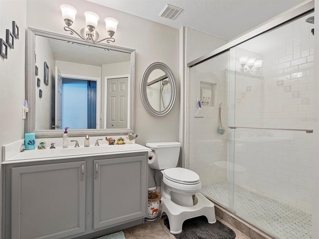 549 Placid Run Road Orange City, FL 32763 - Photo 14 of 20 a bathroom with a toilet sink and mirror