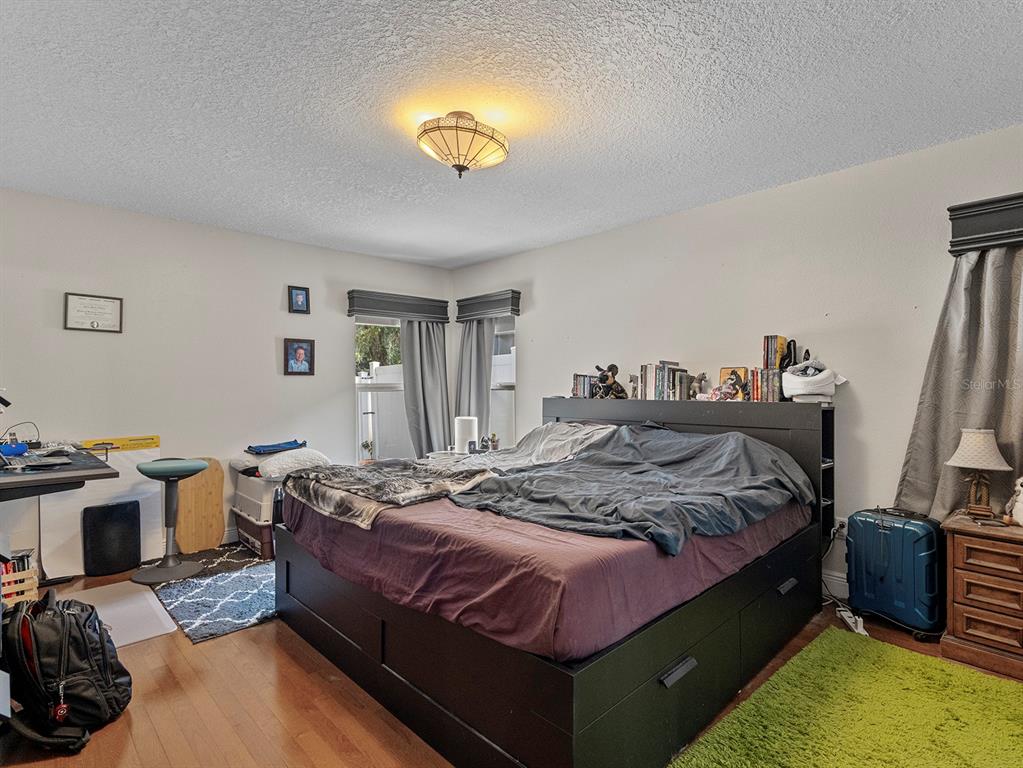 549 Placid Run Road Orange City, FL 32763 - Photo 15 of 20 a bedroom with a bed and a chandelier