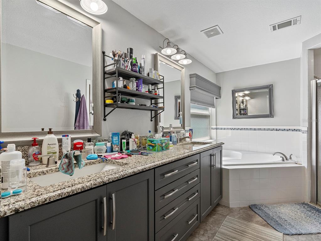 549 Placid Run Road Orange City, FL 32763 - Photo 16 of 20 a bathroom with a granite countertop sink double vanity and a mirror