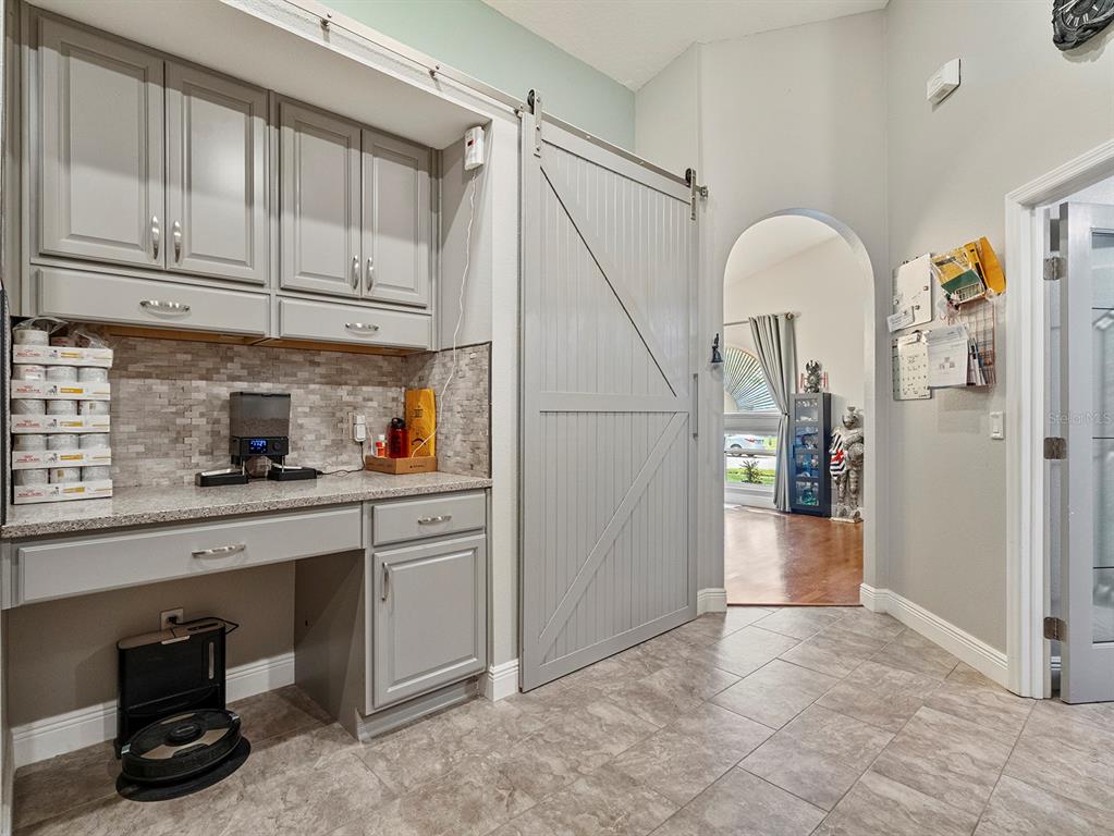 549 Placid Run Road Orange City, FL 32763 - Photo 7 of 20 a kitchen with stainless steel appliances granite countertop a refrigerator and a sink