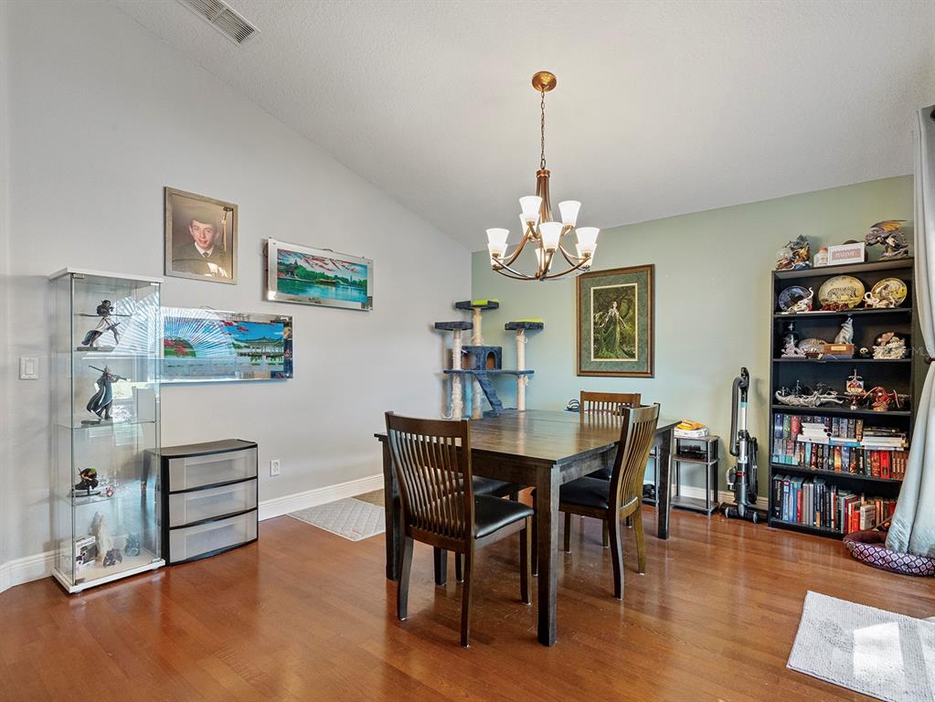 549 Placid Run Road Orange City, FL 32763 - Photo 10 of 20 a view of a dining room with furniture and chandelier