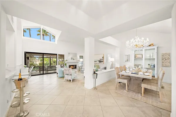 a view of a dining room with furniture a chandelier and wooden floor