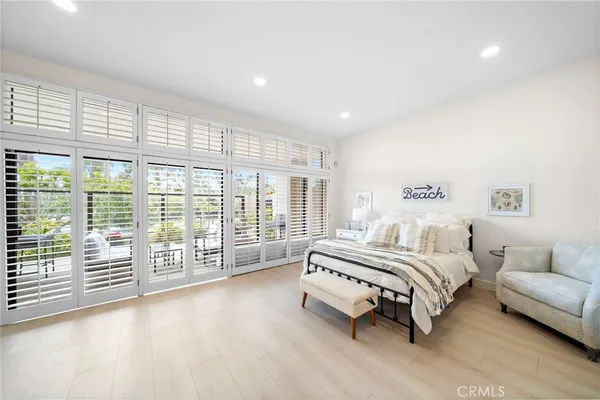 a living room filled with furniture and floor to ceiling windows