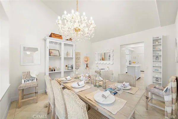 a kitchen with granite countertop a sink and white cabinets