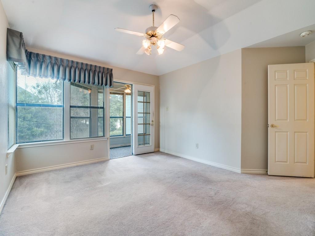 9981 Waterfront Trail Rowlett, TX 75087 - Photo 16 of 26 an empty room with chandelier fan and windows