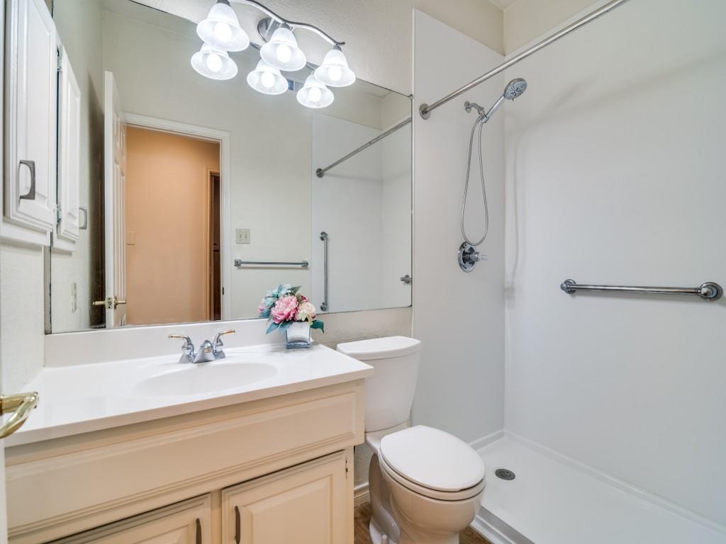 9981 Waterfront Trail Rowlett, TX 75087 - Photo 19 of 26 a bathroom with a sink a toilet a mirror and shower