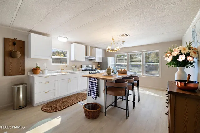 a kitchen with sink cabinets and dining table chair