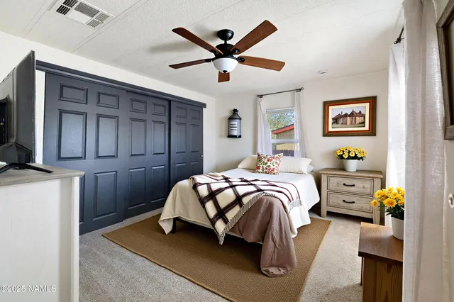 a bedroom with a bed and ceiling fan