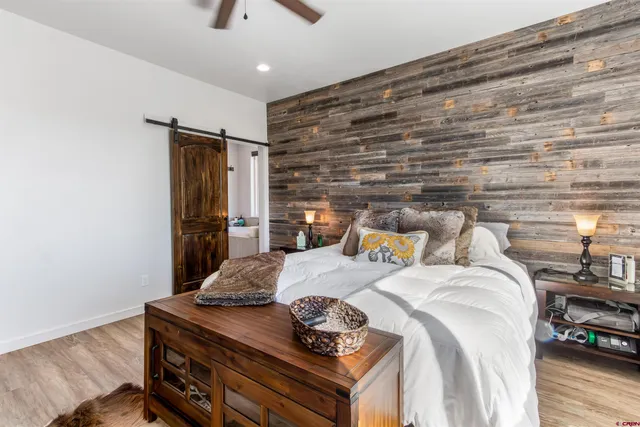 a bedroom with a bed and a wooden floor