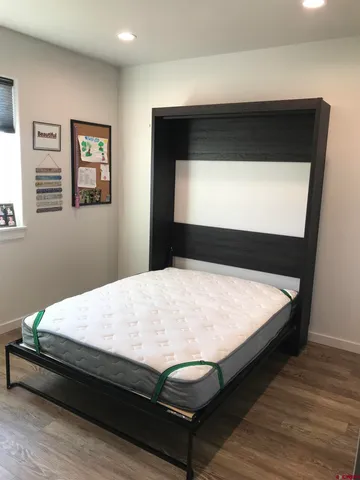 a bed sitting in a bedroom next to a window