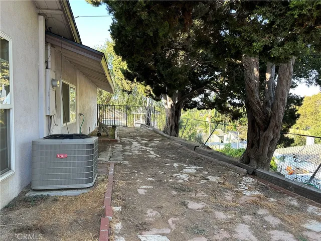 a view of a house with a tree beside it