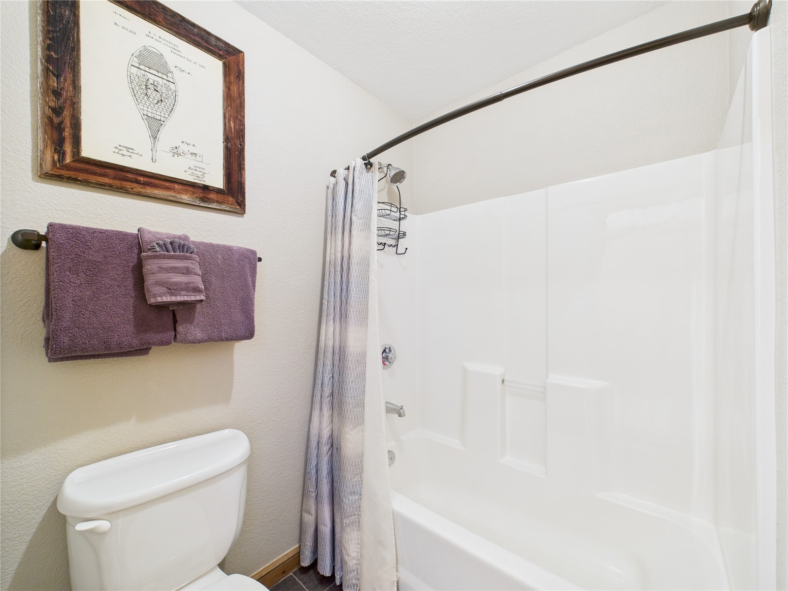 27 Lake Ridge Circle, Unit 1842 Keystone, CO 80435 - Photo 30 of 50 Clean and bright combo with curved shower rod and built-in shelving—perfect for relaxing after outdoor adventures.