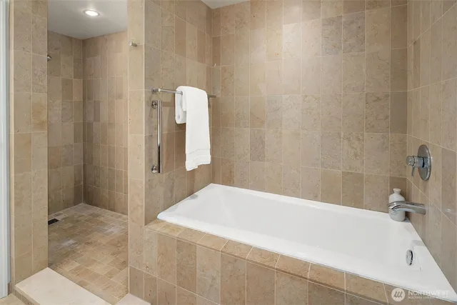 a bathroom with a bathtub and shower