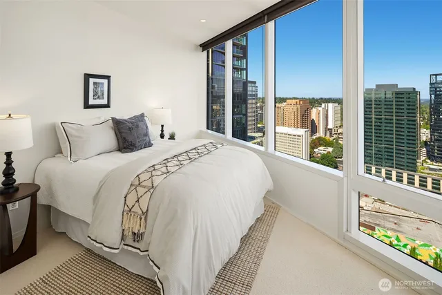 a bed sitting in a bedroom next to a large window