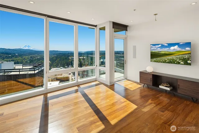 a living room with couch large pool table and a flat screen tv