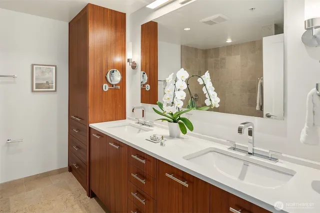 a bathroom with a double vanity sink and a mirror