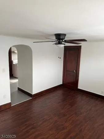 a view of a livingroom with wooden floor and a sink